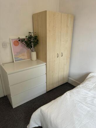 A bright and inviting double bedroom featuring ...