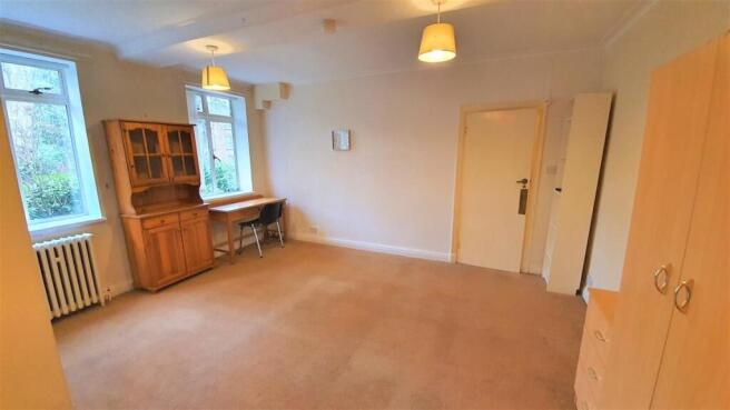 Spacious room with study desk and natural light...