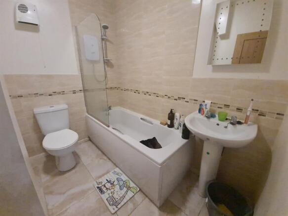 Bright, modern bathroom with a full-size bathtu...