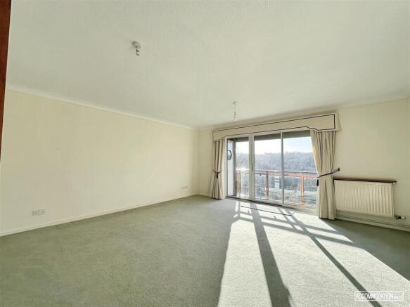 Spacious bright lounge with large balcony doors...