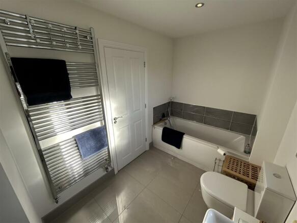 FAMILY BATHROOM SHOWING BATH WITH HAND SHOWER.jpg