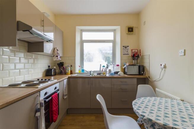 Bright kitchen with dining table and appliances...