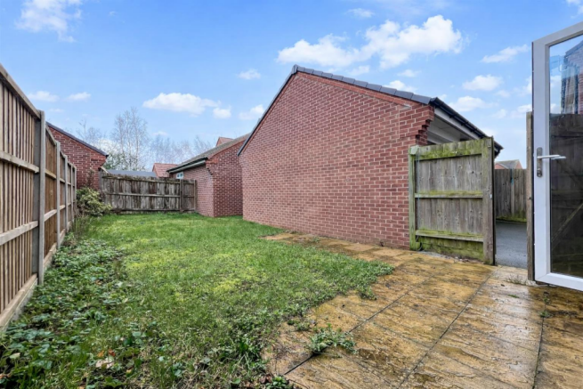 Sunny suburban backyard with open gate (1).png