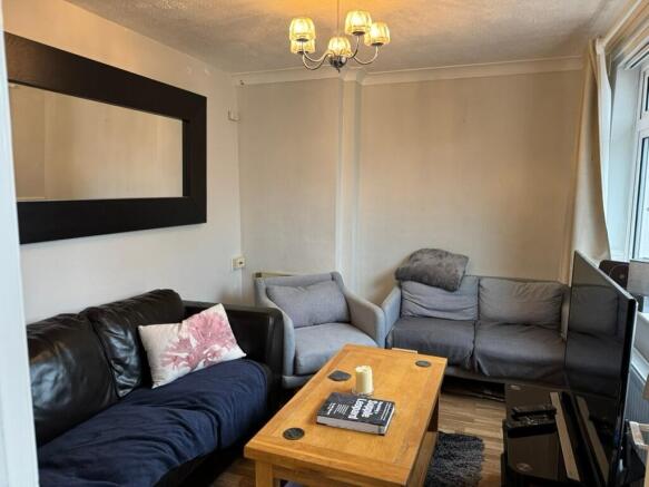 Cozy furnished living room with mixed seating i...