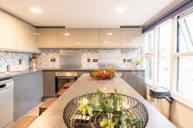 A modern and stylish kitchen featuring ample co...