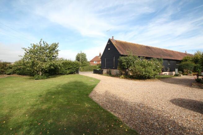 Extensive driveway adjoins lawned garden