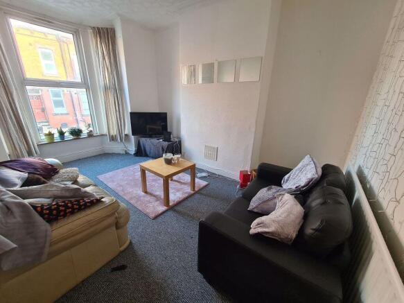 A welcoming living room with abundant natural l...