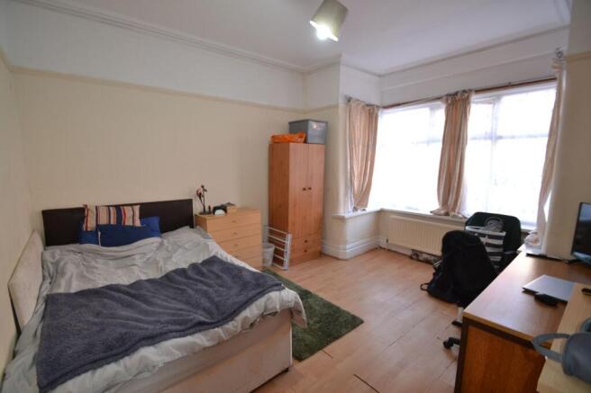 Bright, well-proportioned bedroom with a large ...