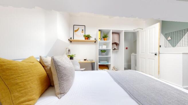 A bright and inviting double bedroom featuring ...