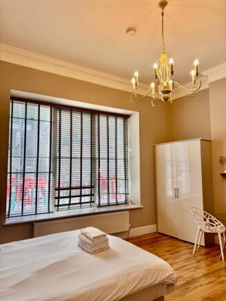 Bright room with large bay window and wardrobe...