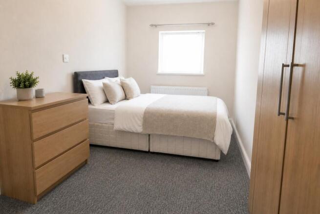 Bright double bedroom with modern oak furniture...