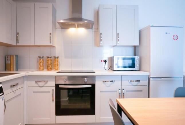 A modern and clean kitchenette featuring ample ...