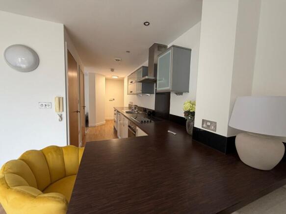 Contemporary open-plan kitchen with dark wood b...