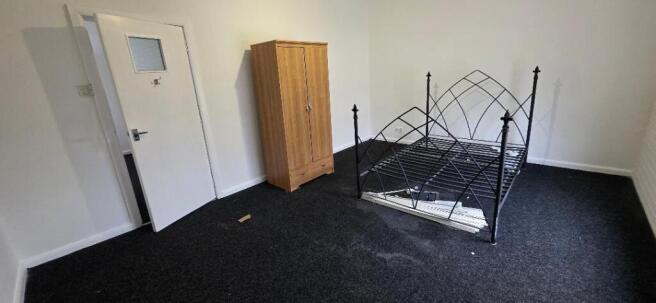 Spacious furnished bedroom with wardrobe and me...