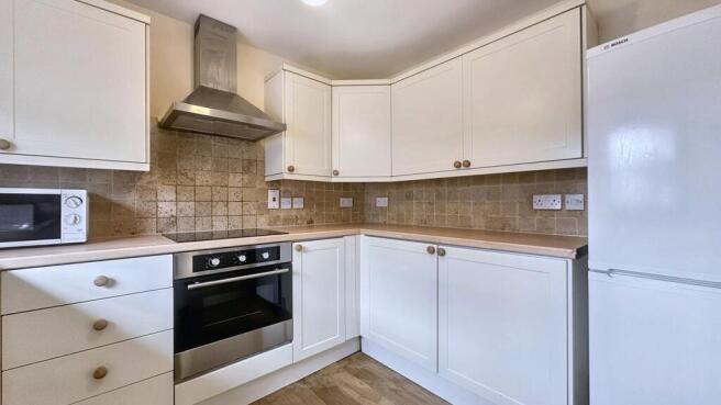 Modern fitted kitchen with sleek appliances...