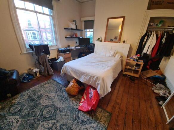 A cozy double bedroom featuring a large window ...