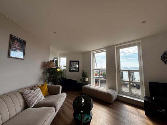 Bright living room with stylish seating and vie...