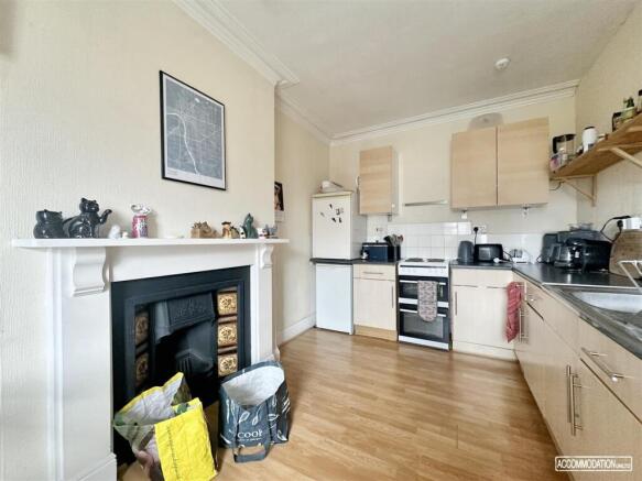 Bright kitchen with a charming feature fireplac...