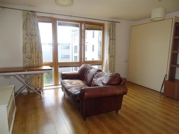 Bright lounge with large windows and sofa...