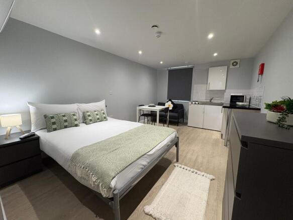 Bright, modern studio with a comfortable double...