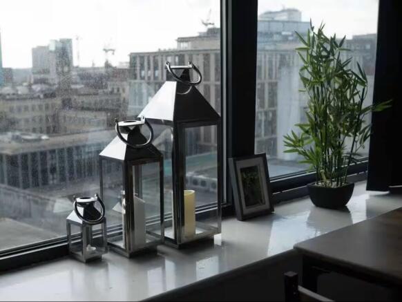 Bright city-view window with decorative lantern...