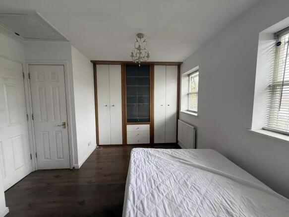 Bright master bedroom with ample built-in stora...