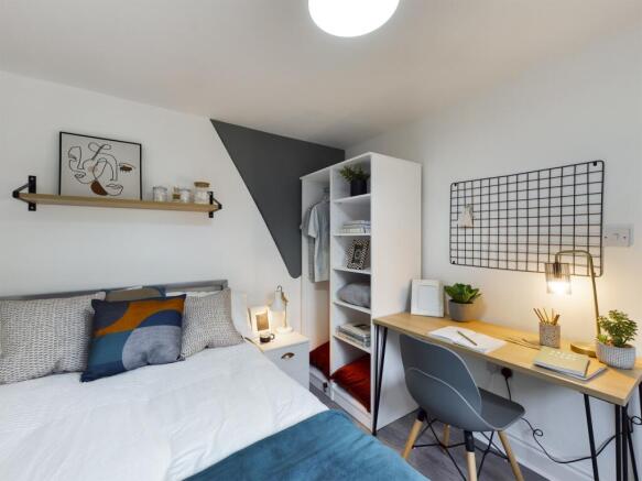 A stylish and well-organized double bedroom wit...