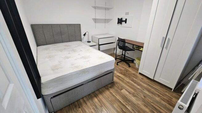 Bright, modern bedroom with a comfortable doubl...