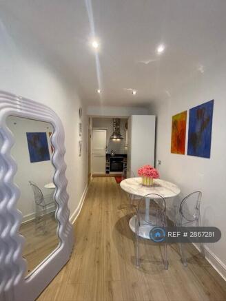Dining Area With Kitchen In The Background