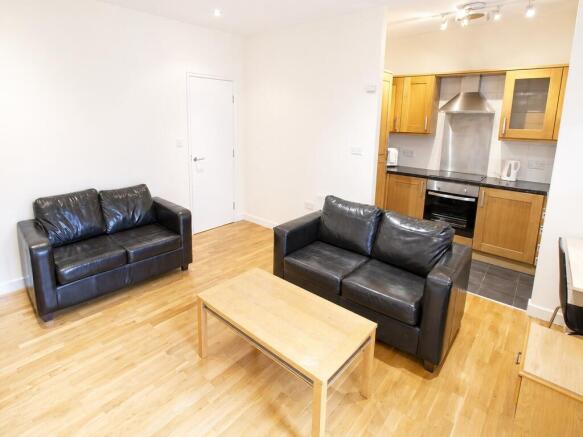 Bright open-plan lounge with sleek leather sofa...
