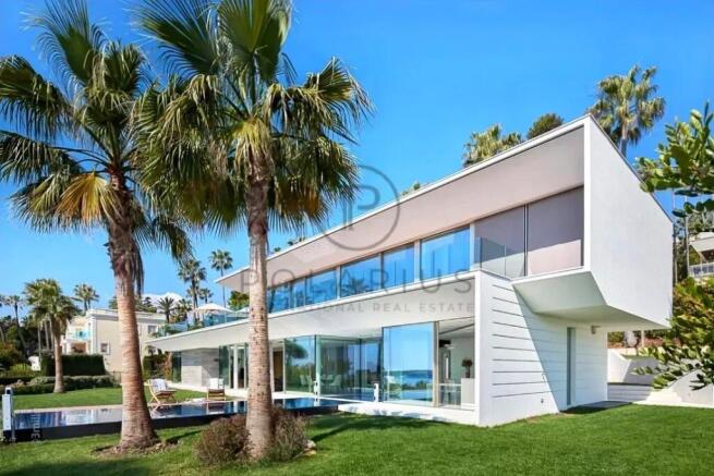 Modern two-story house with large glass windows, s