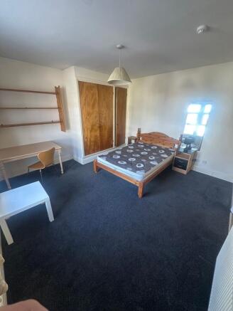 Spacious bedroom with ample desk and storage...