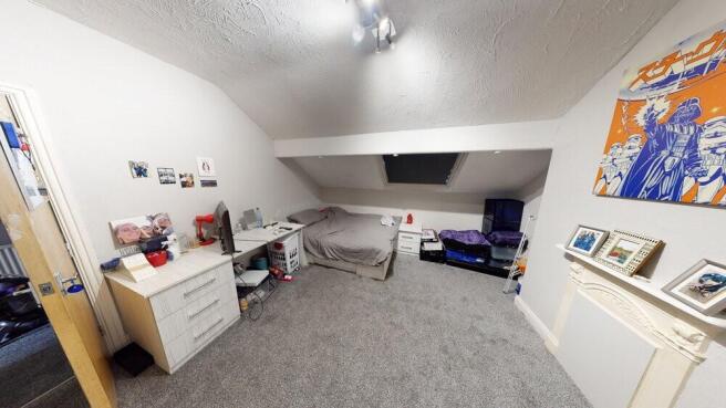 A well-maintained bedroom with a cozy and organ...