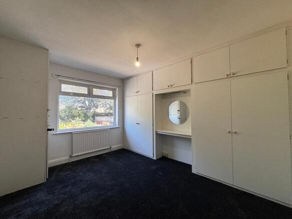 Spacious bedroom with ample built-in storage...