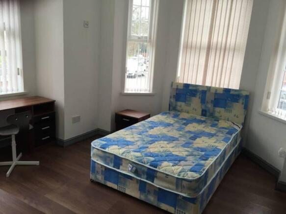 Bright, double bedroom with a patterned double ...