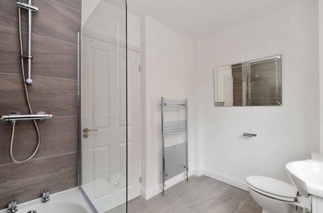 Modern bathroom featuring a spacious shower wit...