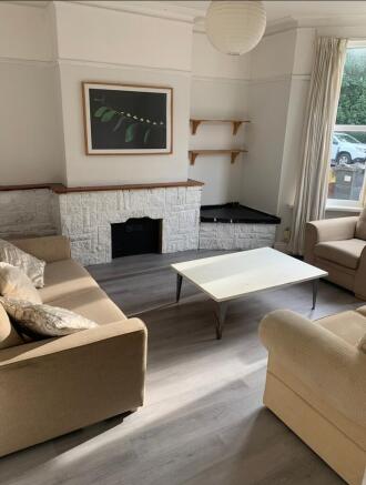 A bright and inviting living room featuring com...