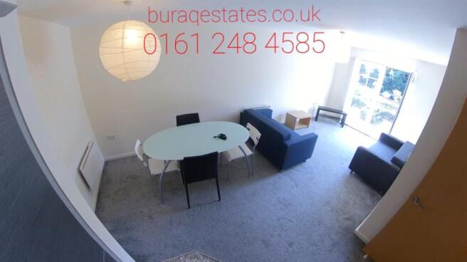 Bright open-plan living room with a dining tabl...