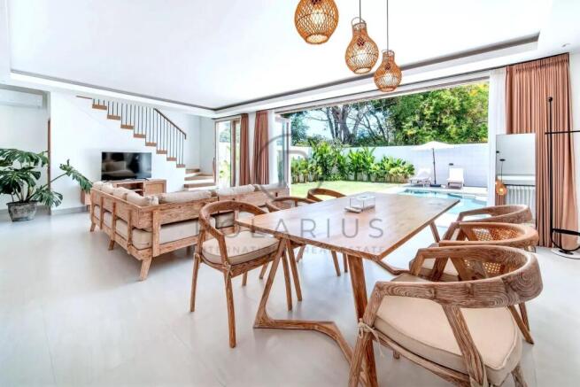 A modern living and dining area features wooden fu