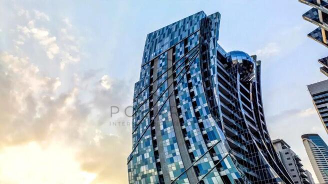 A modern skyscraper with a reflective, angular des