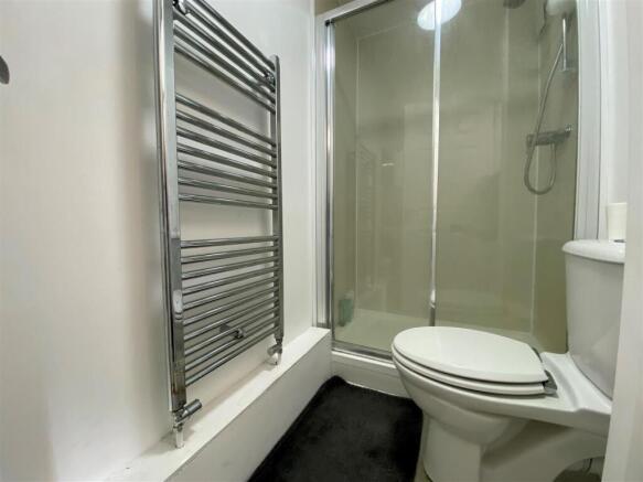 Modern bathroom with shower and heated towel ra...