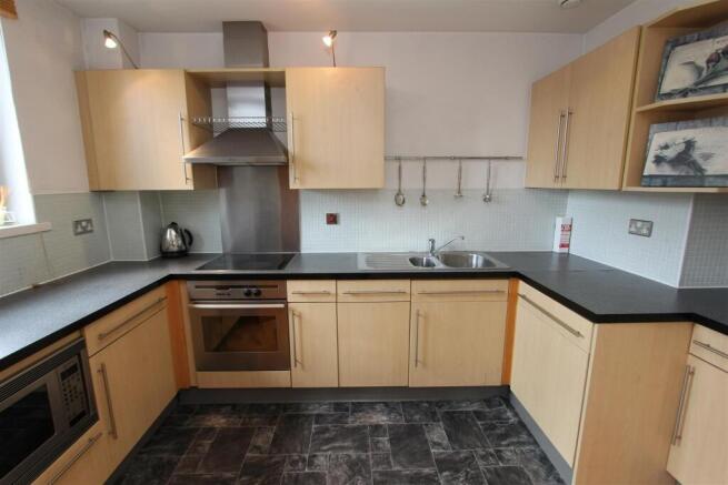 Bright kitchen with ample counter space for soc...
