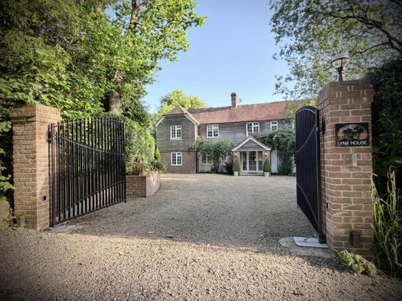 Front elevation, censored automated double gates and private parking for numerous vehicles