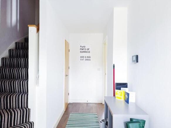 A bright and tidy entrance area with a striped ...