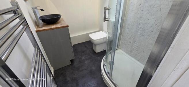 Modern bathroom with walk-in shower and basin...