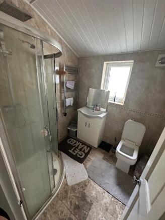 A tidy bathroom featuring a modern shower and c...