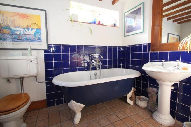 Bathroom has a roll top bath, basin & WC