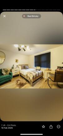 A cozy, well-furnished bedroom featuring a sing...