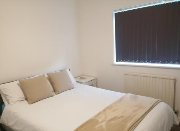 Bright double bedroom with fresh neutral decor...
