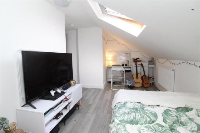 Bright loft room with large TV and skylight...